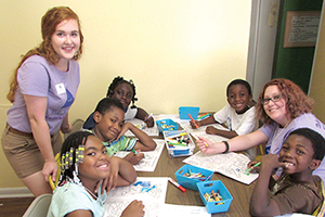 Tutor with children at a summer program