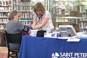 Nurse conducts blood pressure screening at library