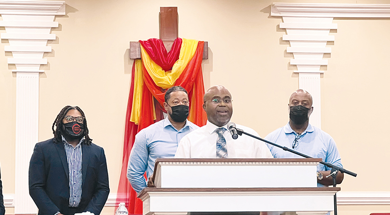 Pastor Sean Dogan, at the microphone, speaks at a men's forum