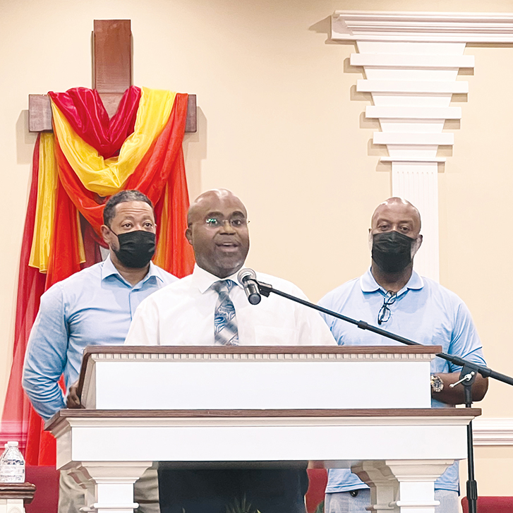 Pastor Sean Dogan, at the microphone, speaks at a men's forum