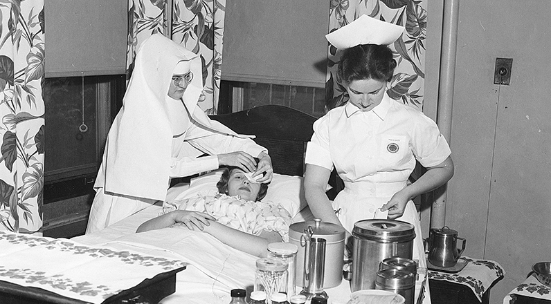Sr. Joanne Obrochta, SAC, and a fellow nurse care for a patient at St. Mary’s Medical Center in Huntington, West Virginia, in the late 1950s.