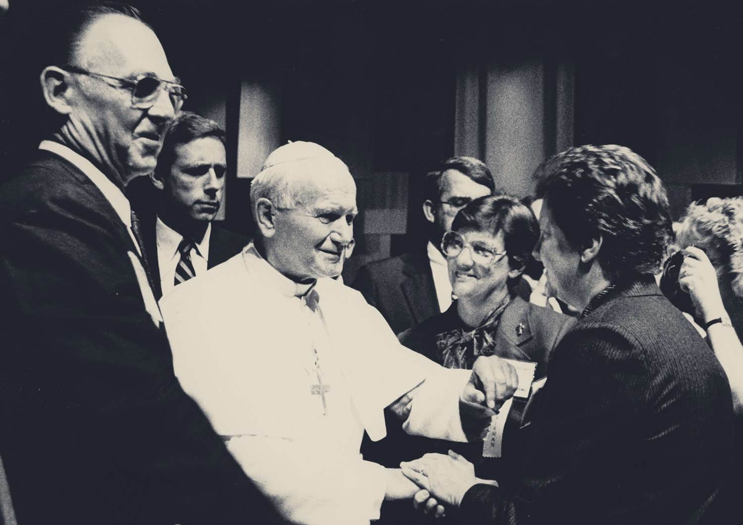 Sr. Mary Eileen Wilhelm, RSM, in glasses, looks on as Pope John Paul II greets attendees at a special CHA membership assembly.