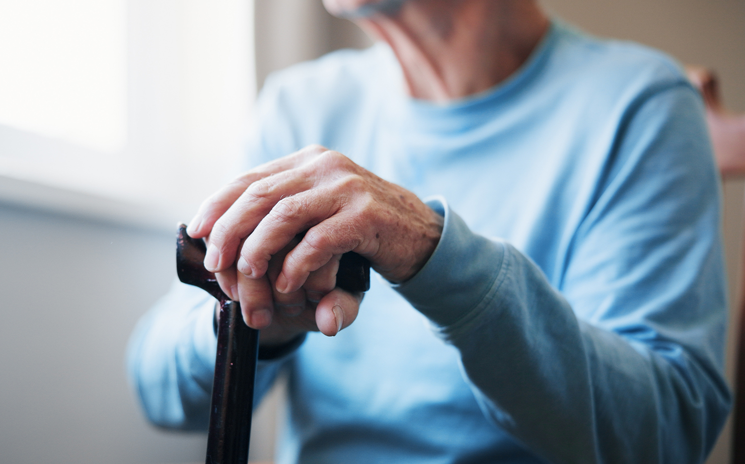 Hands holding a cane