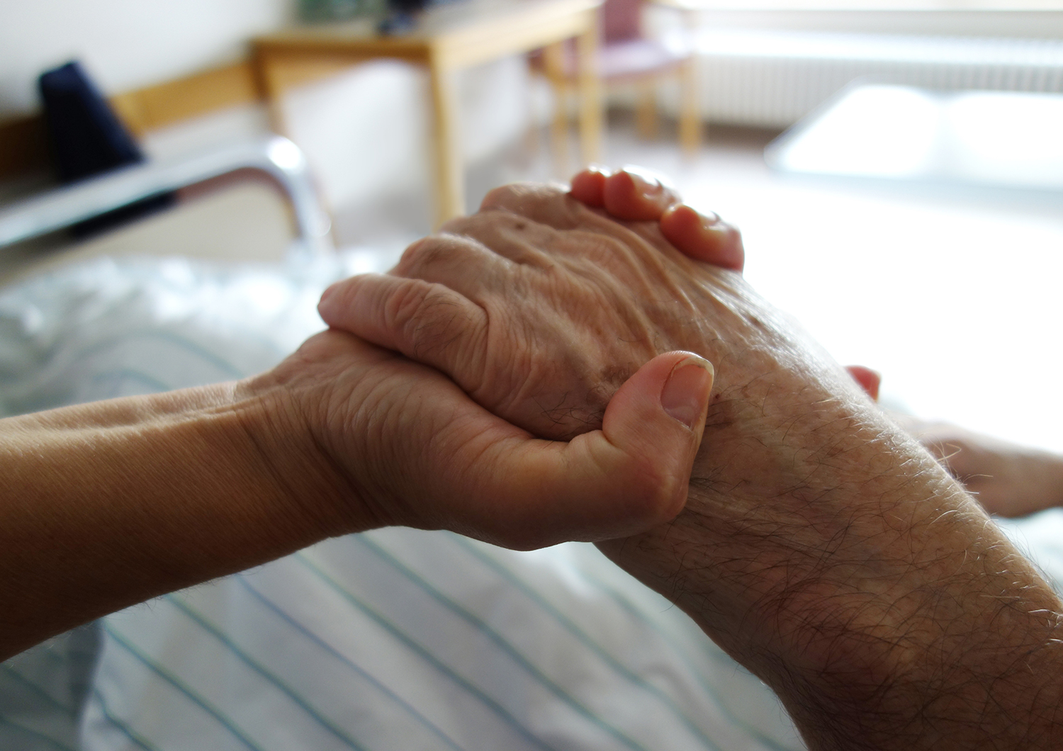 Elderly hands clasping