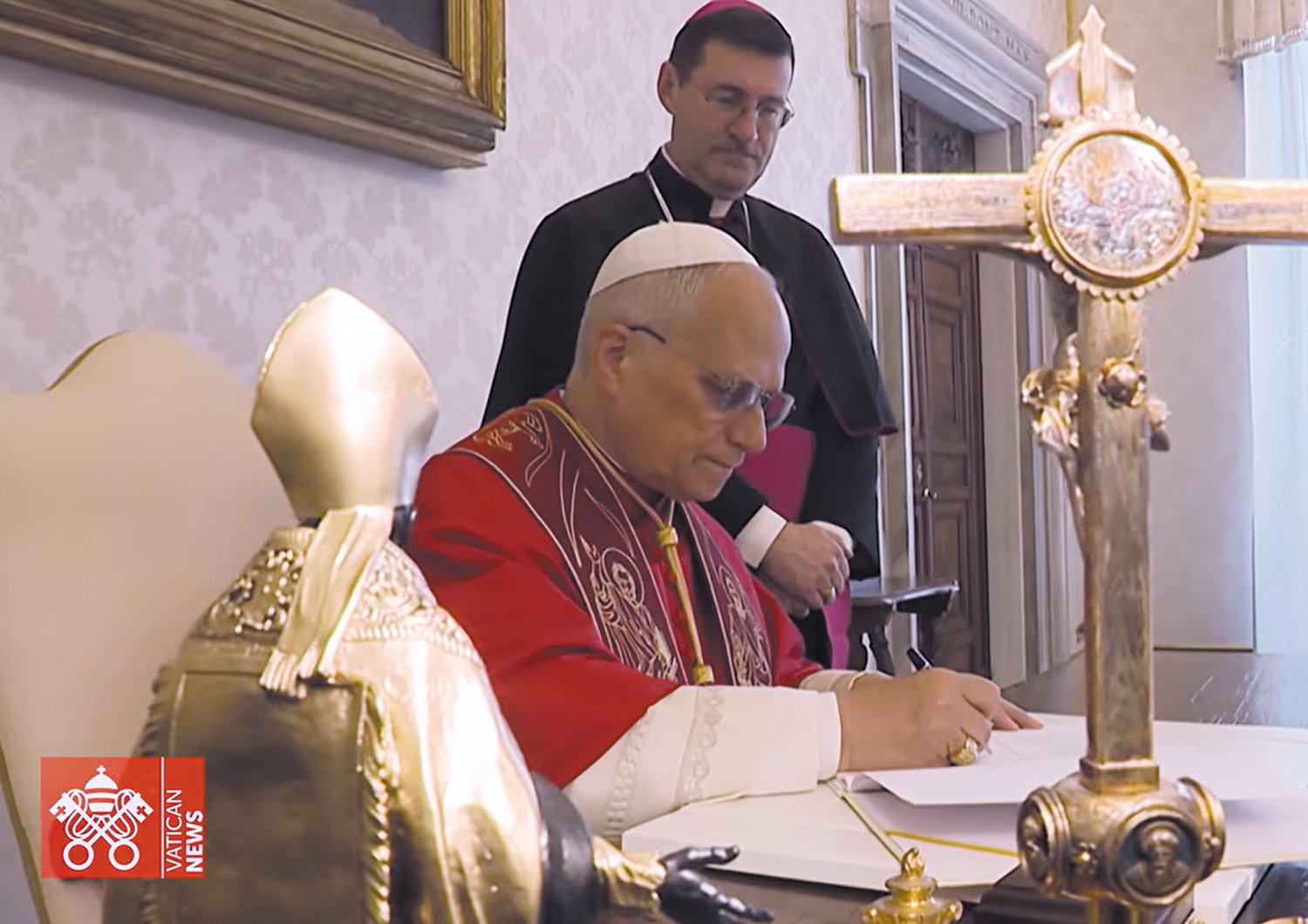 In a screenshot from a video posted by Vatican News, Pope Leo XIV signs Magnifica Humanitas: On Safeguarding the Human Person in the Time of Artificial Intelligence, the encyclical letter.