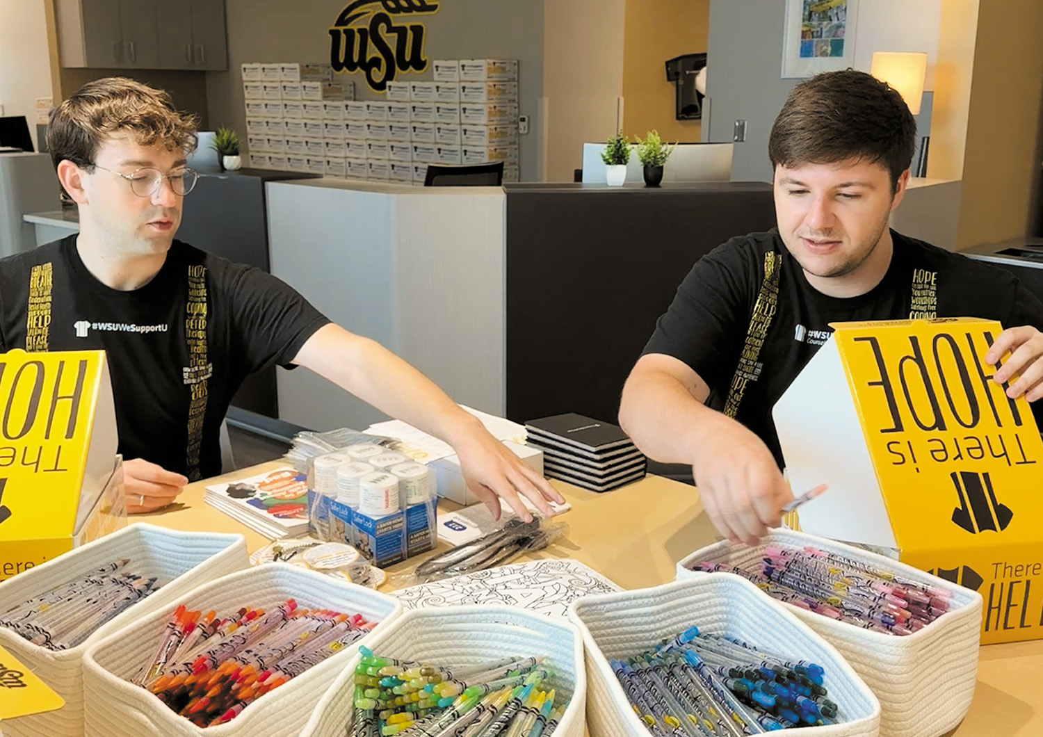 Wichita State University students Ervis Oake, left, and Matt Dixon assemble Hope Kits that will be distributed to Ascension Via Christi hospitals and about two dozen local organizations