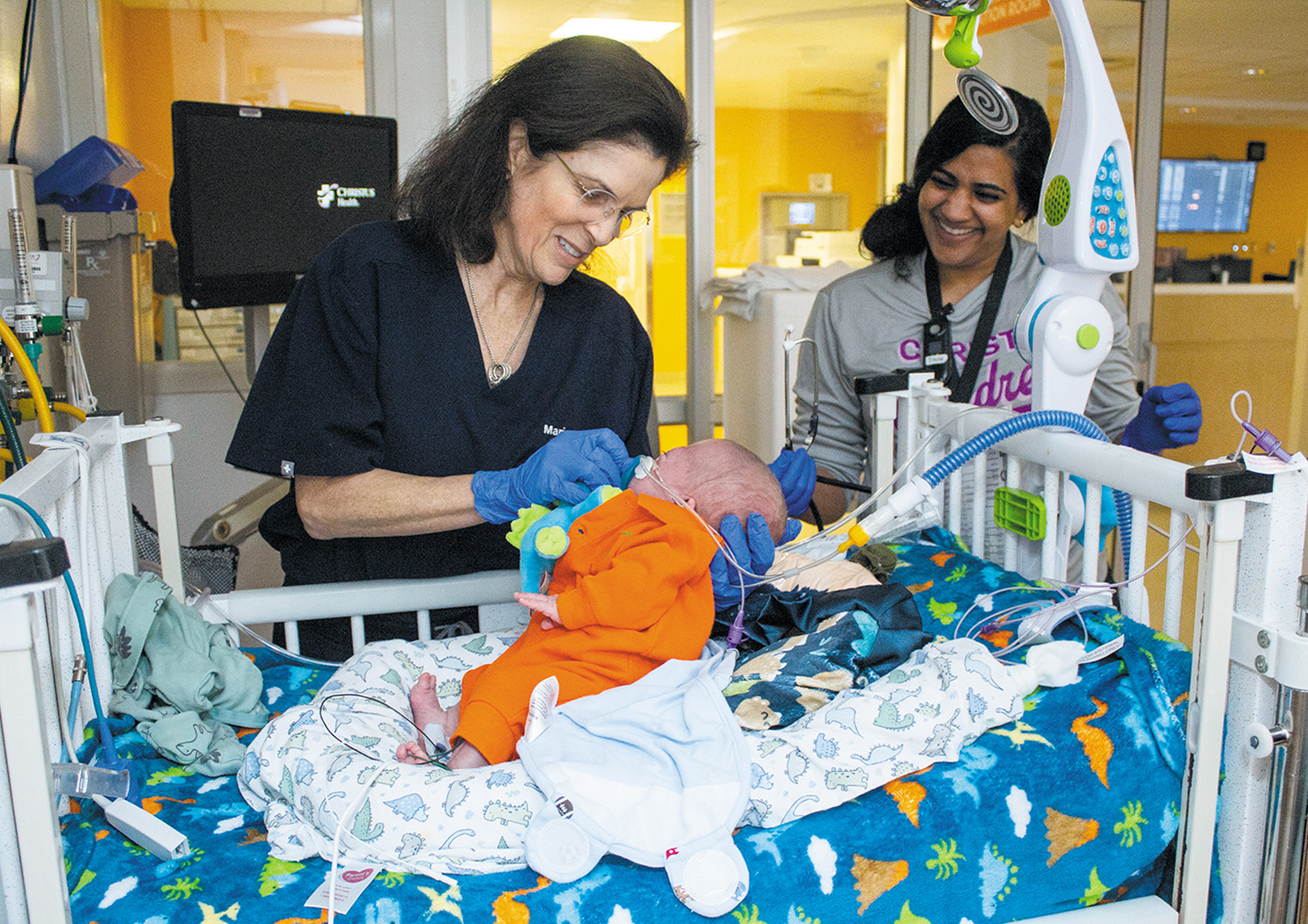 During rounds at CHRISTUS Children’s in San Antonio, Dr. Maria Pierce, left, assesses a baby in the NICU.