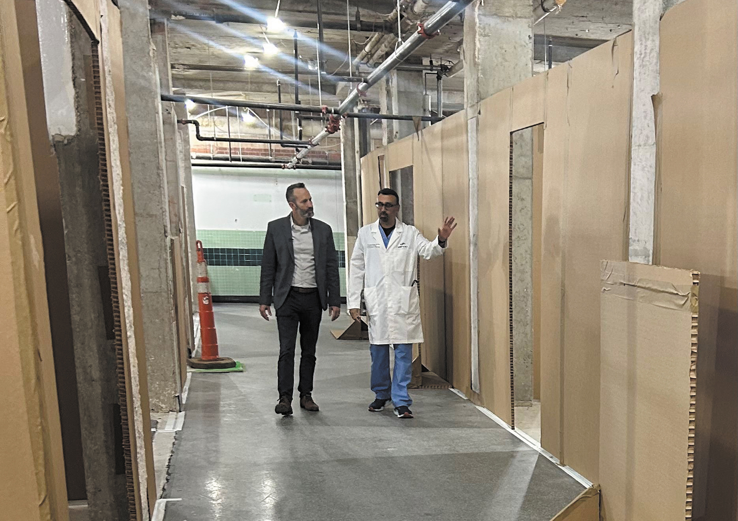 Scott Parker, left, of Miller Architects, walks through a “cardboard city” at SSM Health St. Anthony Hospital’s in Oklahoma City with Dr. Vinodh Jeevanantham, chair of cardiology.